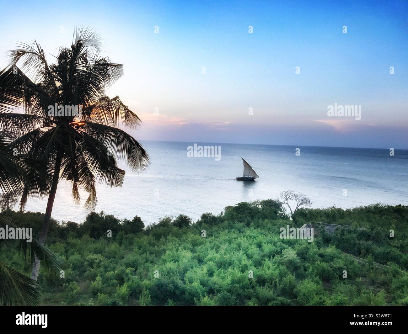 Zanzibar island:Tropical sunset with a sailboat on the sea - Smartphone Captured Stock Image