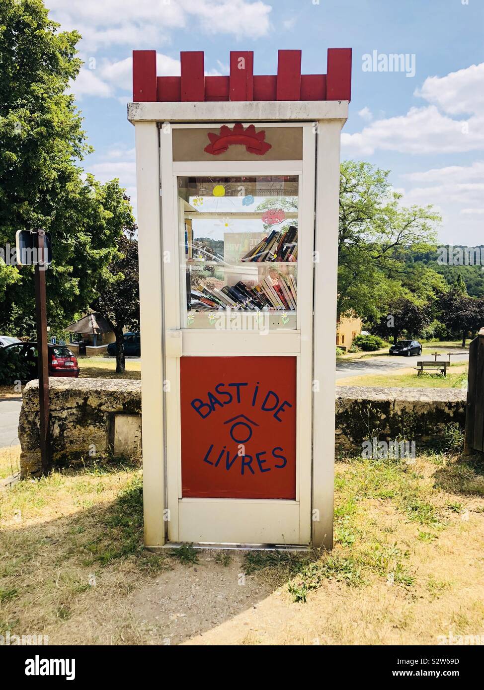 Book exchange in an old telephone box in the bastide town of monpazier in France - Smartphone Captured Stock Image