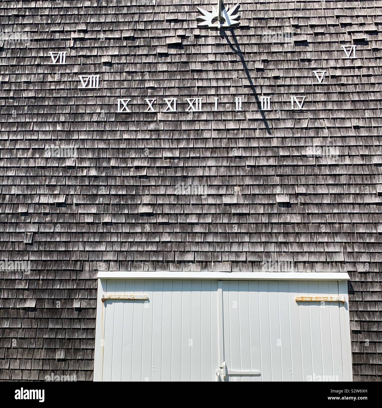 Sundial on the side of a home in the town of Siasconset, Nantucket Island, Massachusetts, United States - Smartphone Captured Stock Image