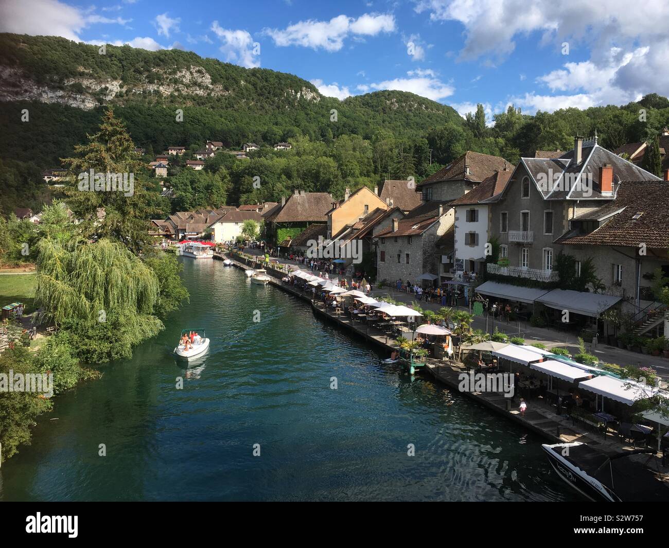 View of Chanaz in France; it lies on the banks of the Canal de Savière. The flower-filled village, nicknamed 'Savoie's Little Venice', has many delights for visitors including boat trips  & cafes. - Smartphone Captured Stock Image