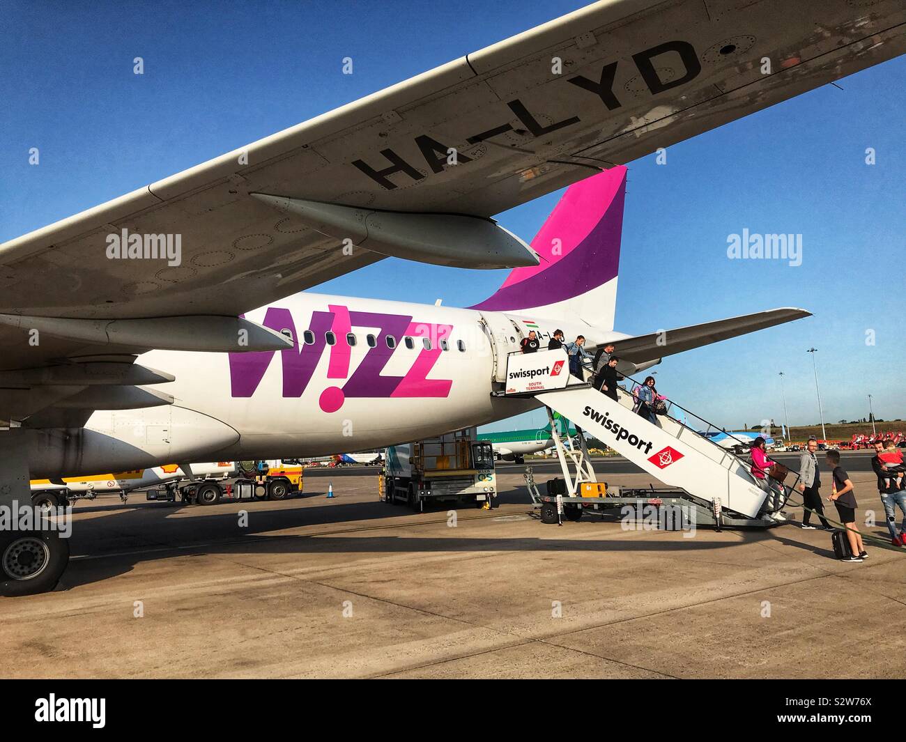 Passengers disembark from a Wizzair Airbus A320. The Hungarian airline is a major European low cost carrier. Stock Photo