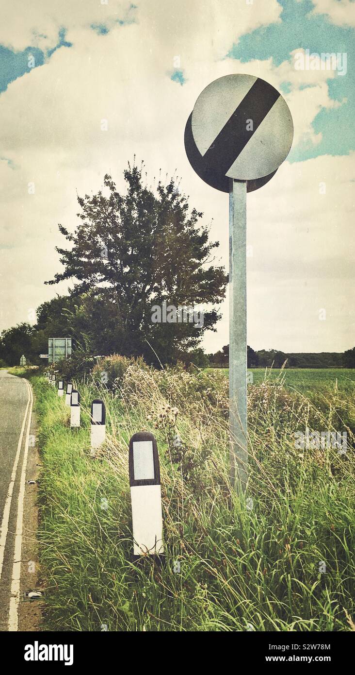 National speed limit sign at roadside in a rural setting Stock Photo