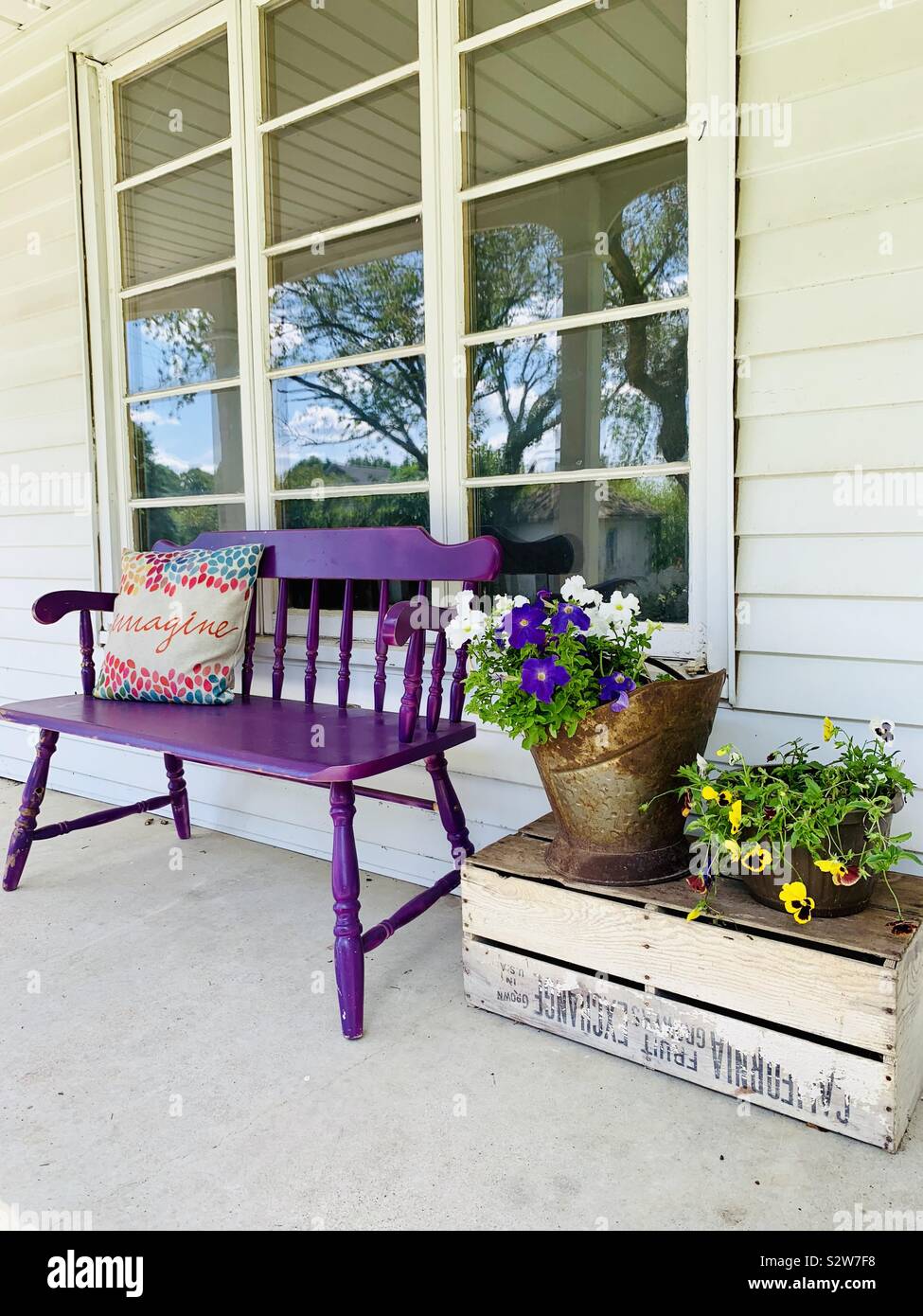 Purple bench and petunias in the summertime on a country porch - Smartphone Captured Stock Image