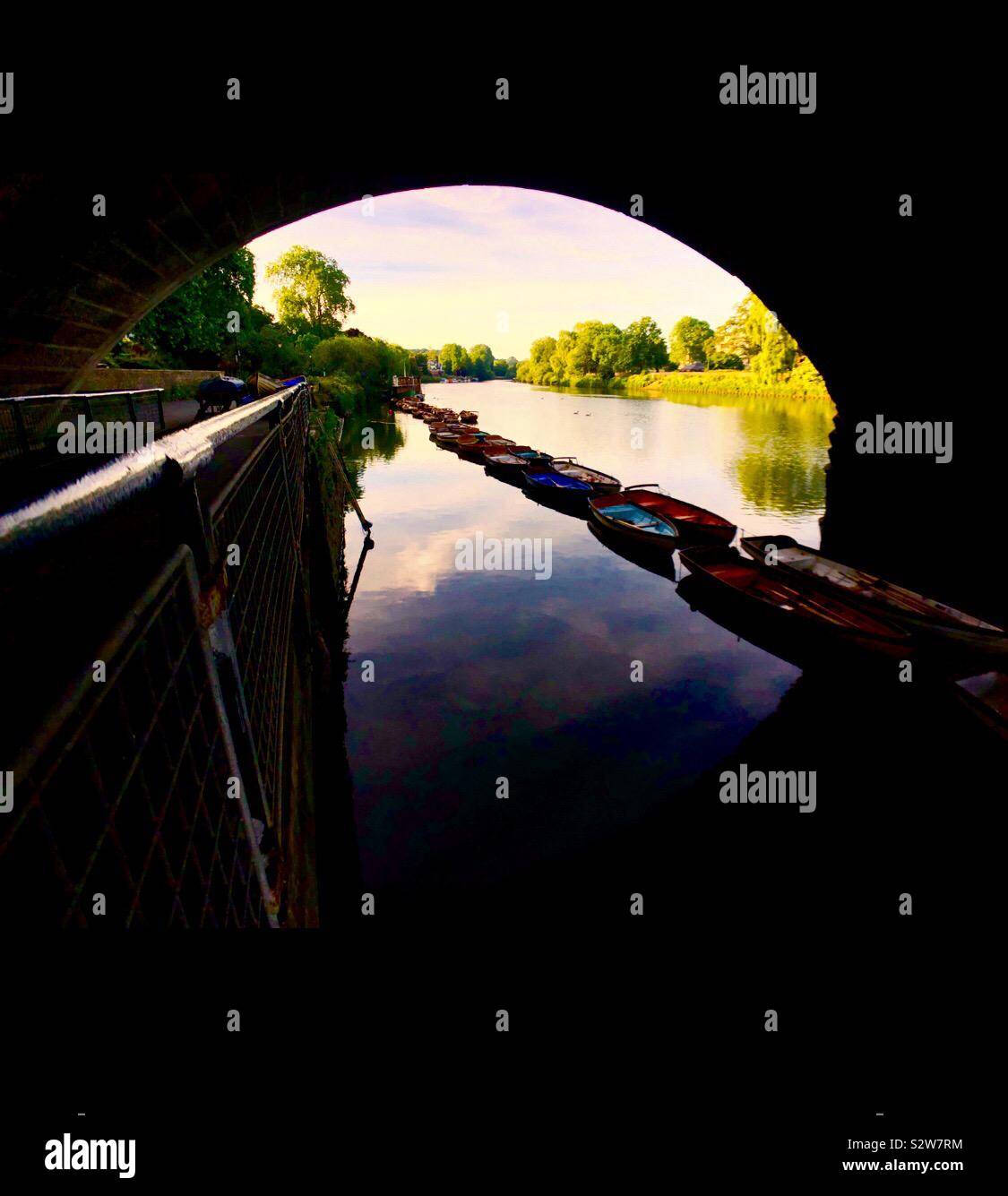 Rowboats in the line under a bridge - Smartphone Captured Stock Image