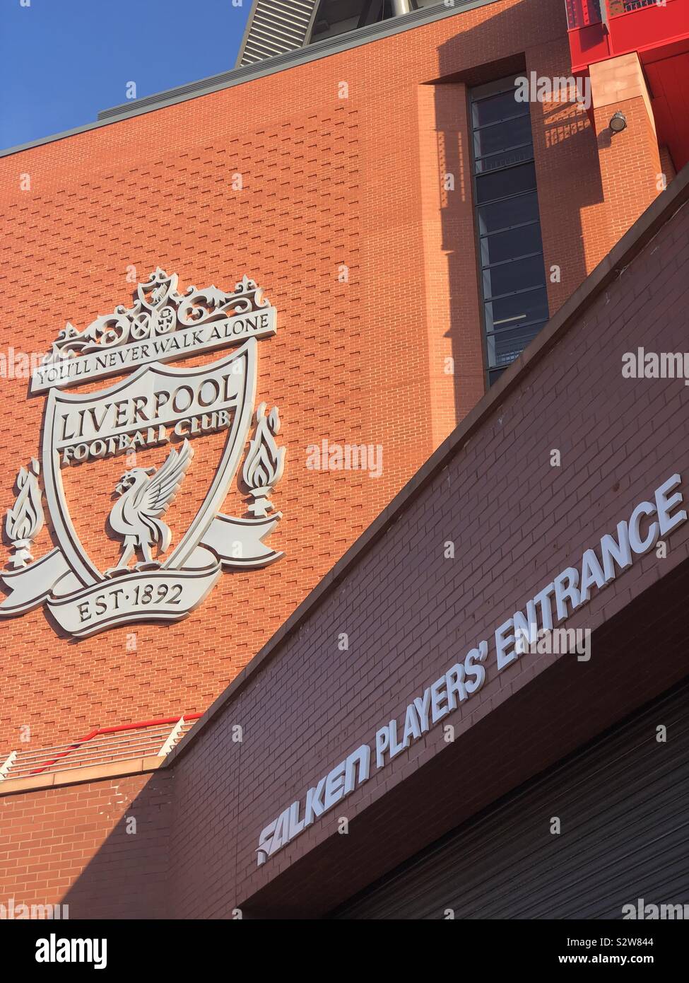 Anfield stadium Liverpool football club. You’ll never walk alone lfc crest badge on the stadium wall. Stock Photo