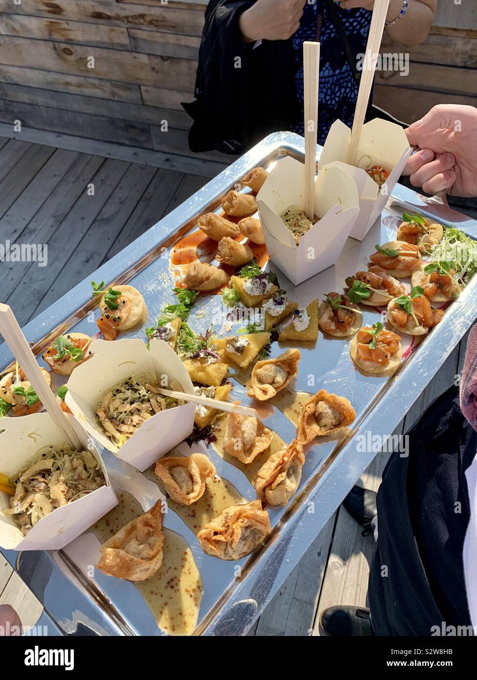 A serving tray filled with hors d'oeuvres being held by a server Stock  Photo - Alamy