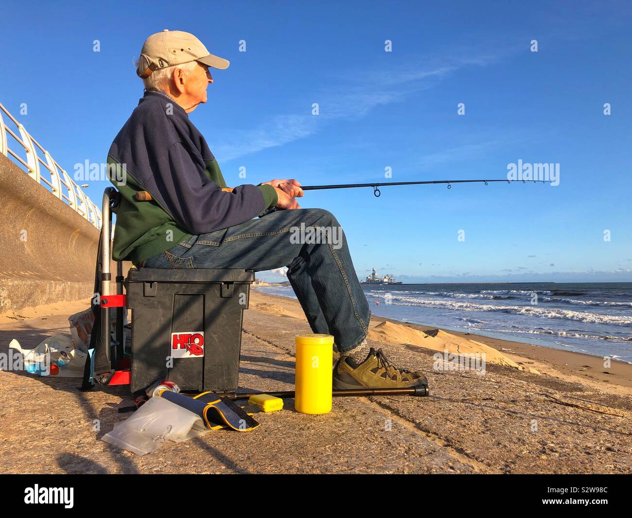 Elderly gentleman sea fishing, Aberavon, South Wales. Stock Photo