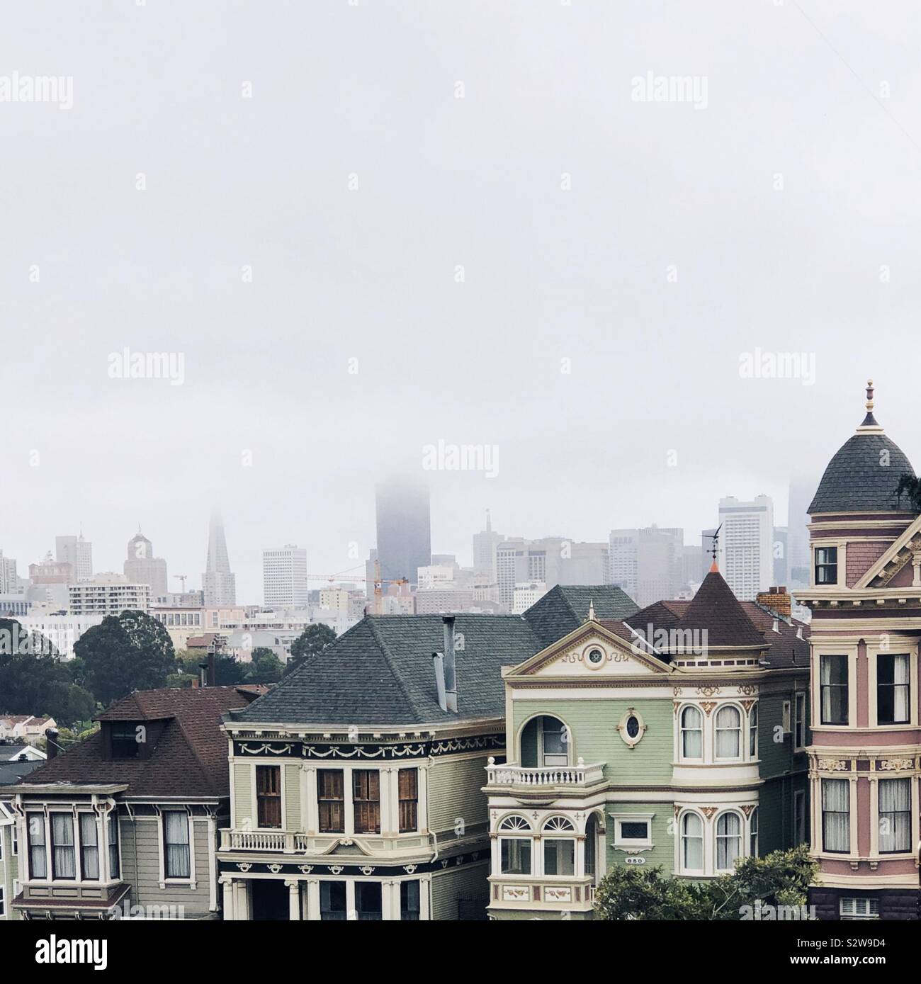 Iconic painted ladies in San Francisco on foggy day Stock Photo