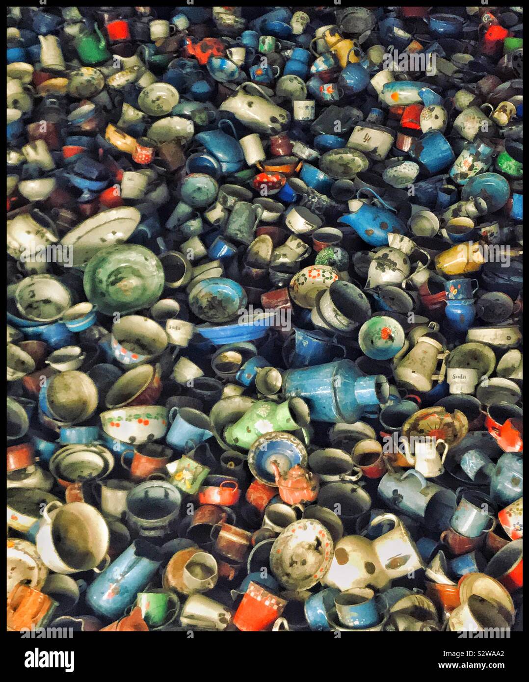 A massive pile of household crockery items on display at the Auschwitz Memorial Museum in Poland. These items were confiscated by the Nazis from the mostly Jewish Concentration Camp inmates. © CH. - Smartphone Captured Stock Image