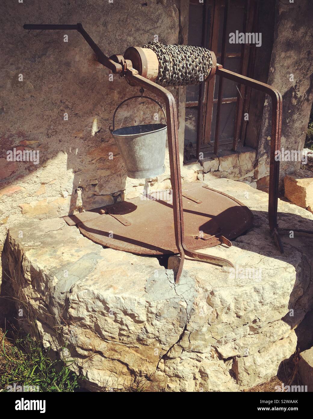 Original French water well in rural France. The well is on a farm and would still work / is working. - Smartphone Captured Stock Image