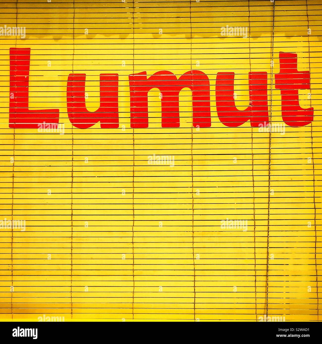 The town name painted on a bamboo shade blind in front of a shop in Lumut, Perak, Malaysia - Smartphone Captured Stock Image