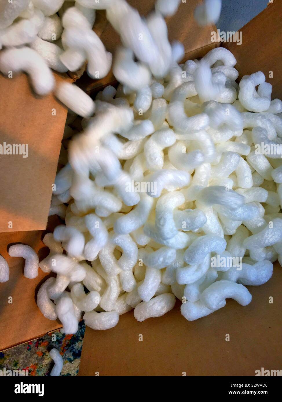 Motion blur of Styrofoam peanuts filling a cardboard packing box - Smartphone Captured Stock Image