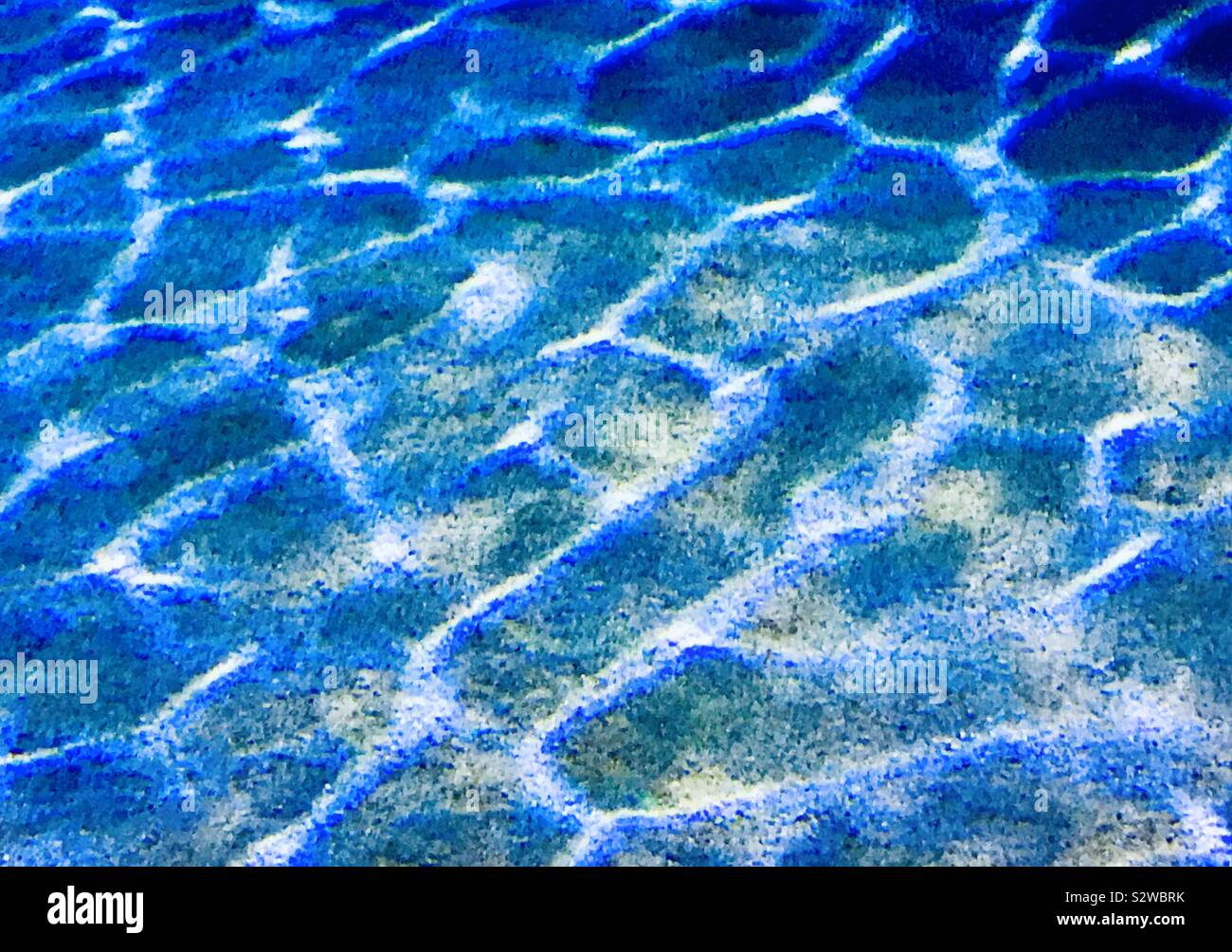 Light reflecting onto the sand profile under the sea in the Algarve, Portugal. Stock Photo