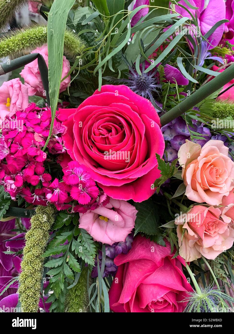 Beautiful flower arrangement with deep pink and pale pink roses in full bloom. - Smartphone Captured Stock Image