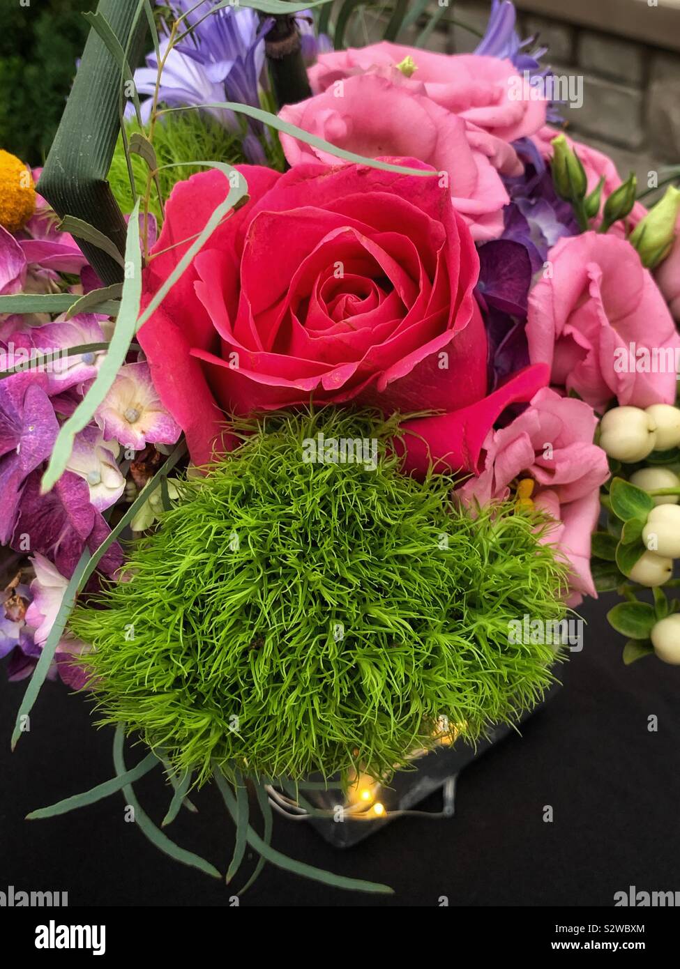 Beautiful flower arrangement with deep pink roses in full bloom. - Smartphone Captured Stock Image