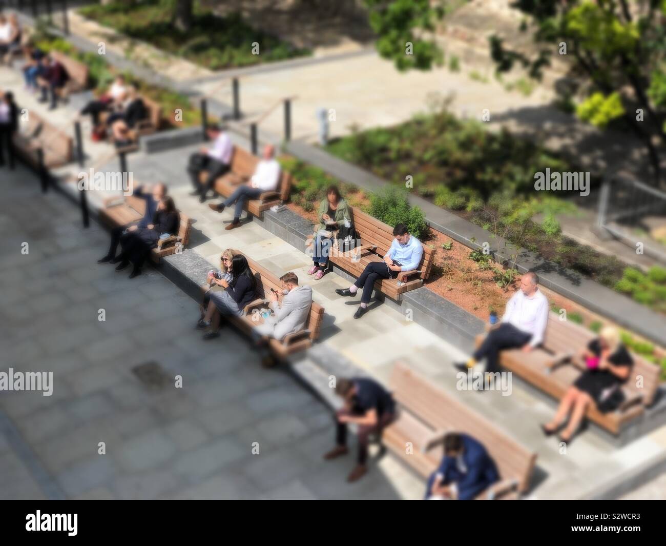 Office workers enjoying their lunchtime break in the sun. London Wall. City of London Stock Photo