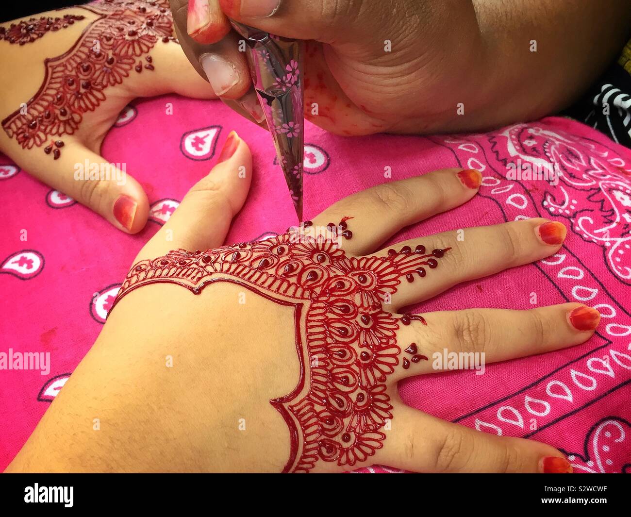 Henna 'tattoos' being applied at a night street market, Sitiawan, Perak, Malaysia - Smartphone Captured Stock Image