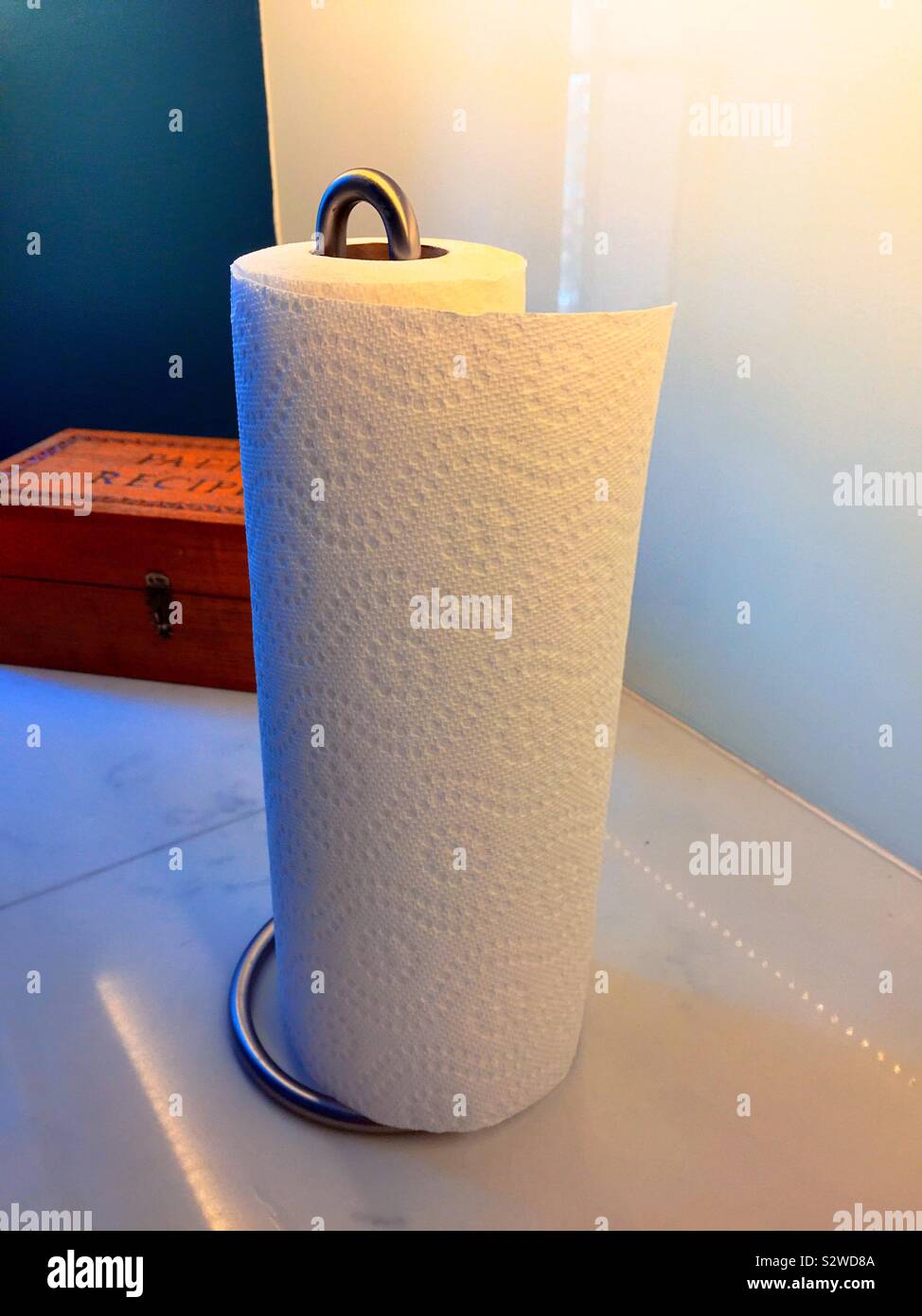 Paper towels on the kitchen counter dispensed by a metal spindle paper