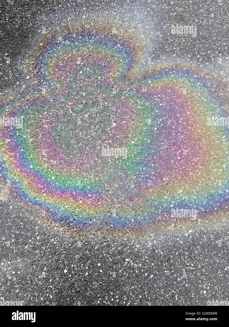 Rainbow oil spill on asphalt Stock Photo Alamy