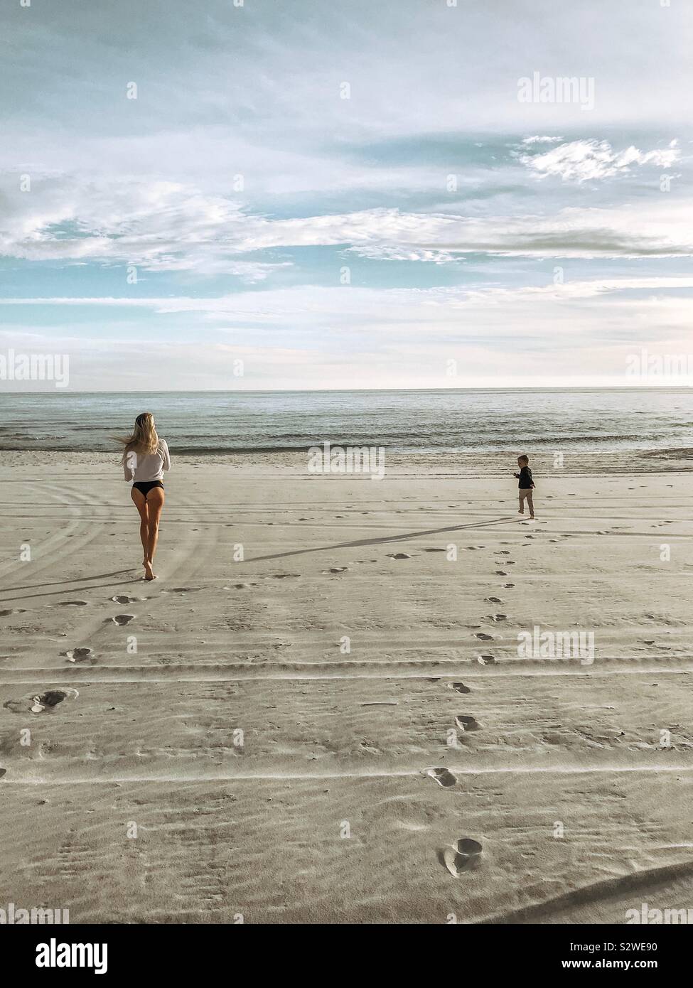Mother and son running on the beach - Smartphone Captured Stock Image
