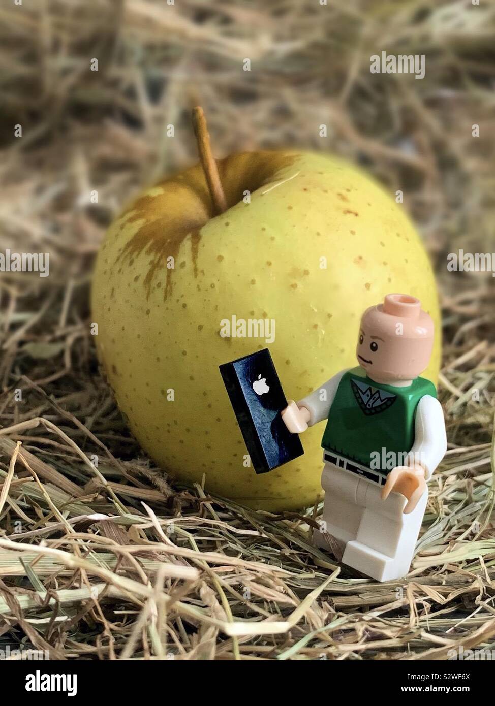 Concept of Lego figure with new Apple ipad Pro and iOS 13.  iPhone pro iOS 14.  iPhone 12 iPhone SE.  Fortnite.  iOS 15.  iPhone 13.  iPhone 15.  iPhone 14 - Smartphone Captured Stock Image