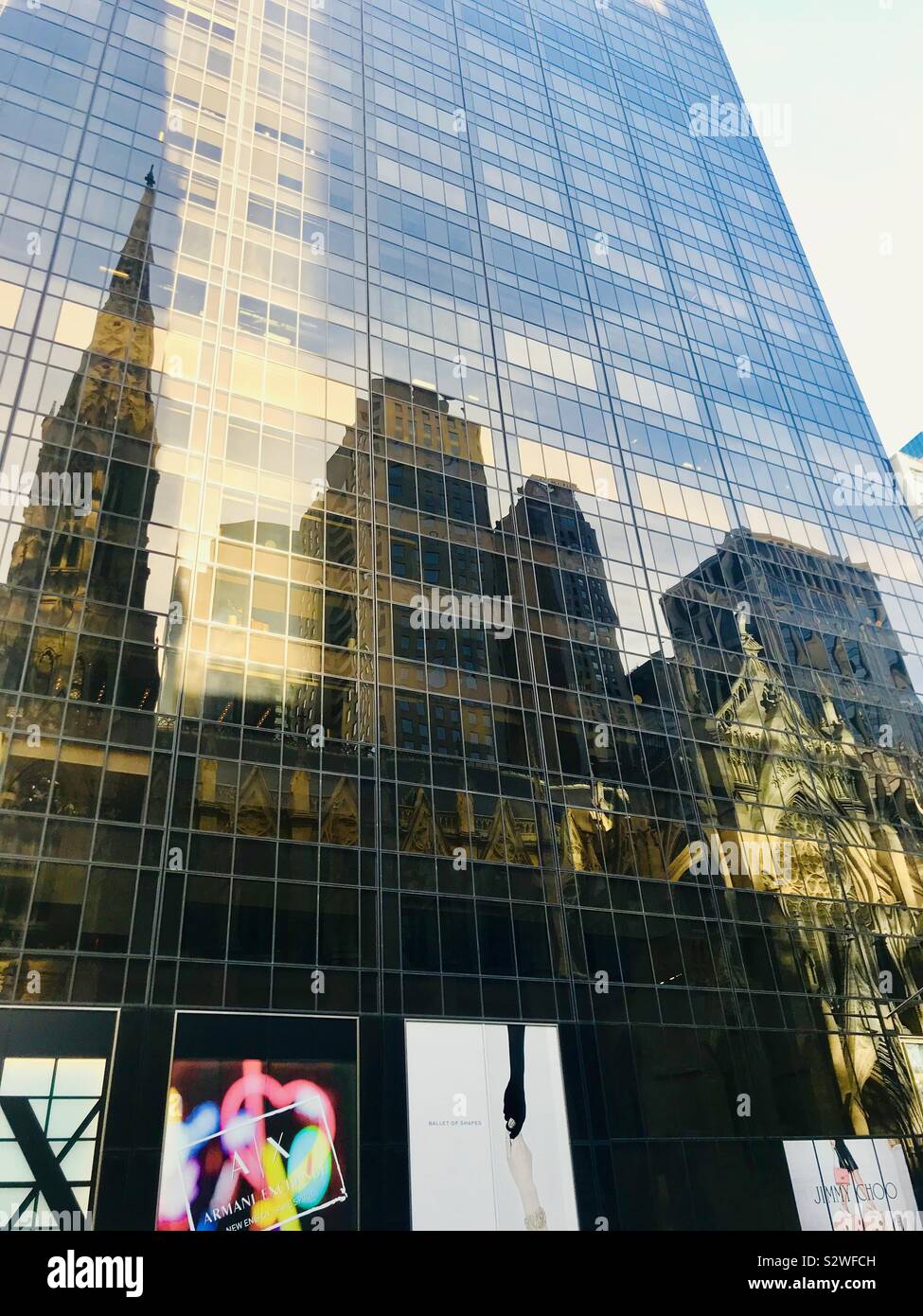 Reflection of St Patrick’s Cathedral on 5th Avenue, New York City, Manhattan Stock Photo