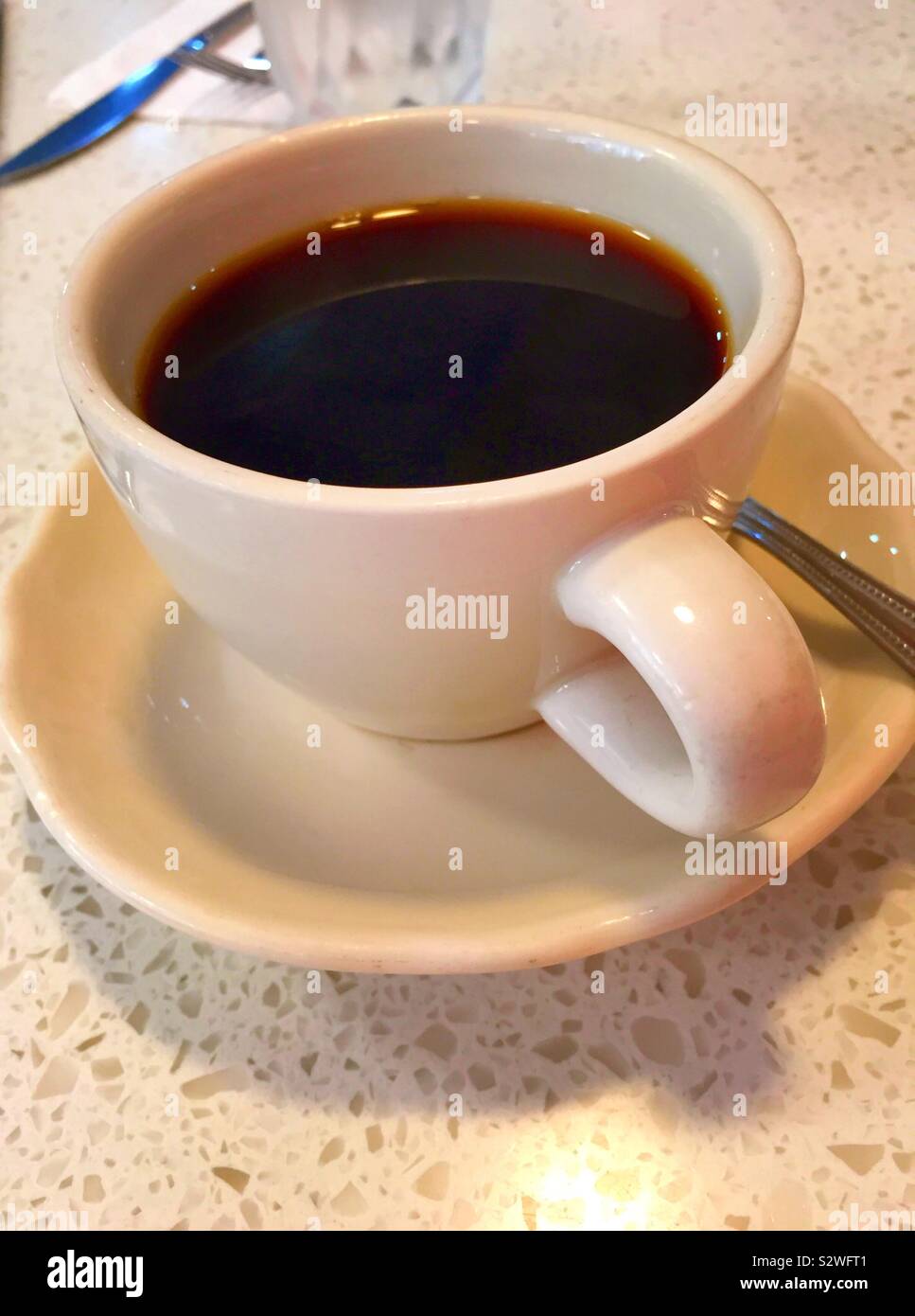 Cup of black coffee on a saucer at a diner in the United States - Smartphone Captured Stock Image