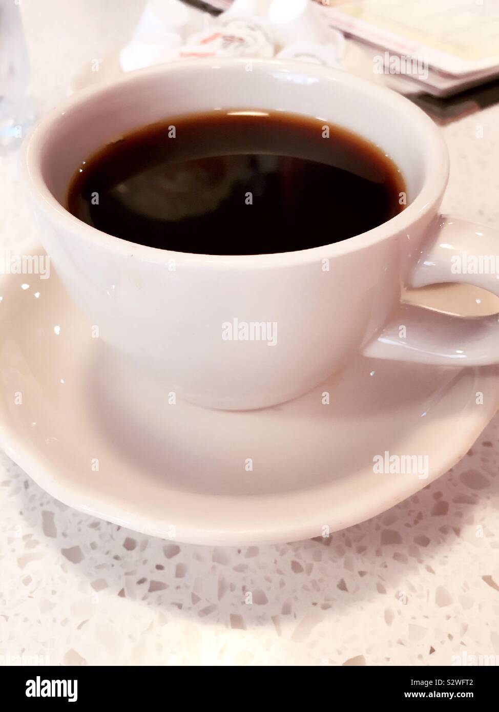 Cup of coffee on a saucer at a diner, USA - Smartphone Captured Stock Image