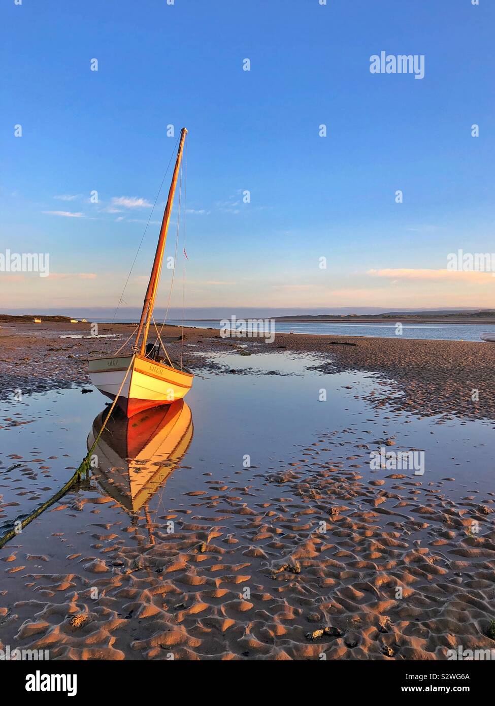 Sailing boat moored on the River Torridge estuary, in dawn light, August. - Smartphone Captured Stock Image Sailing boat moored on the River Torridge estuary, in dawn light, August. - Smartphone Captured Stock Image