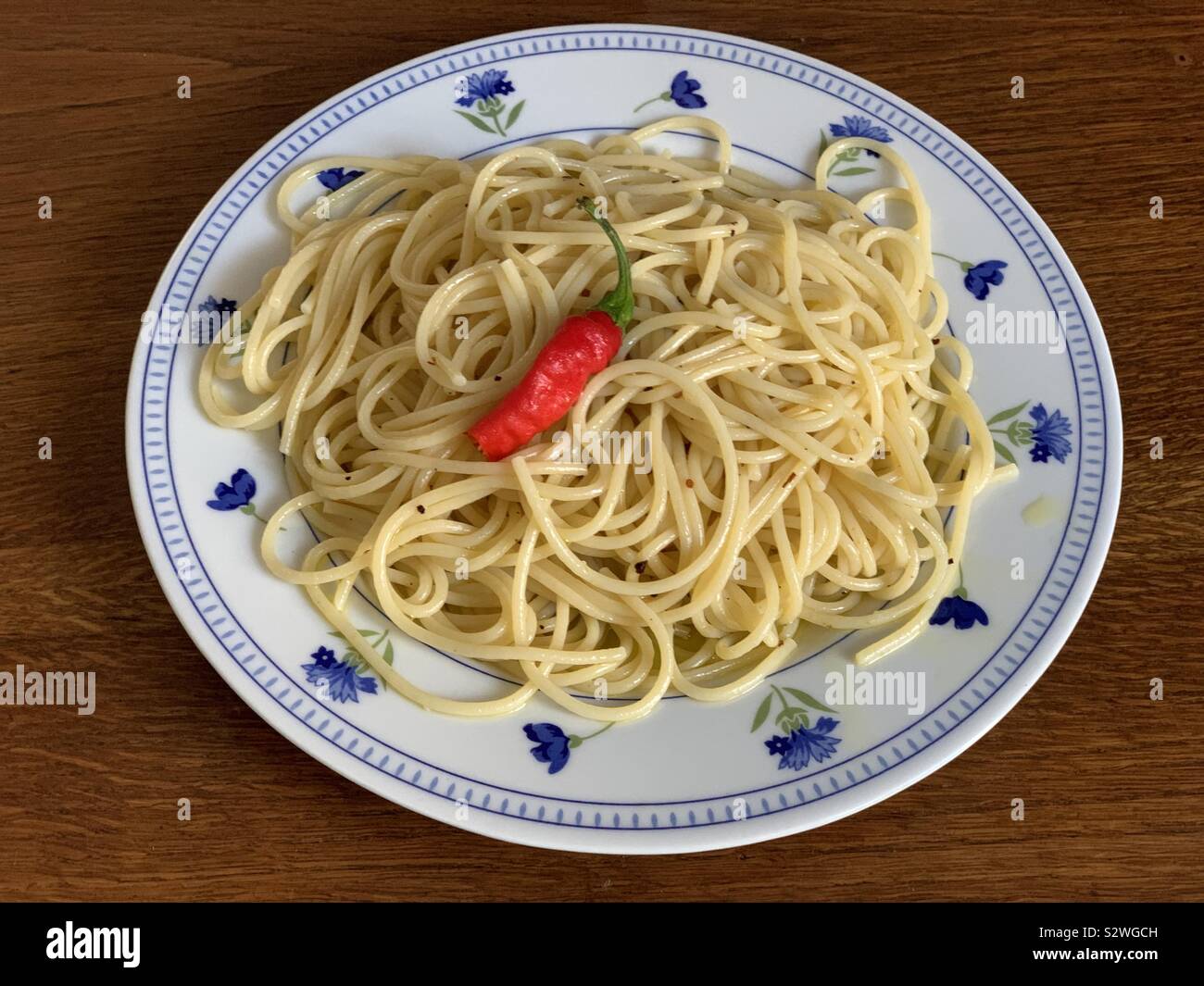 Noodles with garlic, olive oil and hot peppers, typical italian dish - Smartphone Captured Stock Image