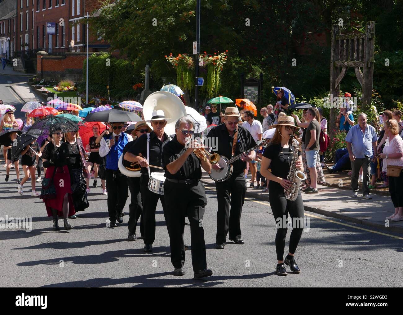 Umbrella March outside the Community Garden in Congleton at the start of the Congleton Jazz and Blues festival. 24th August 2019. Stock Photo