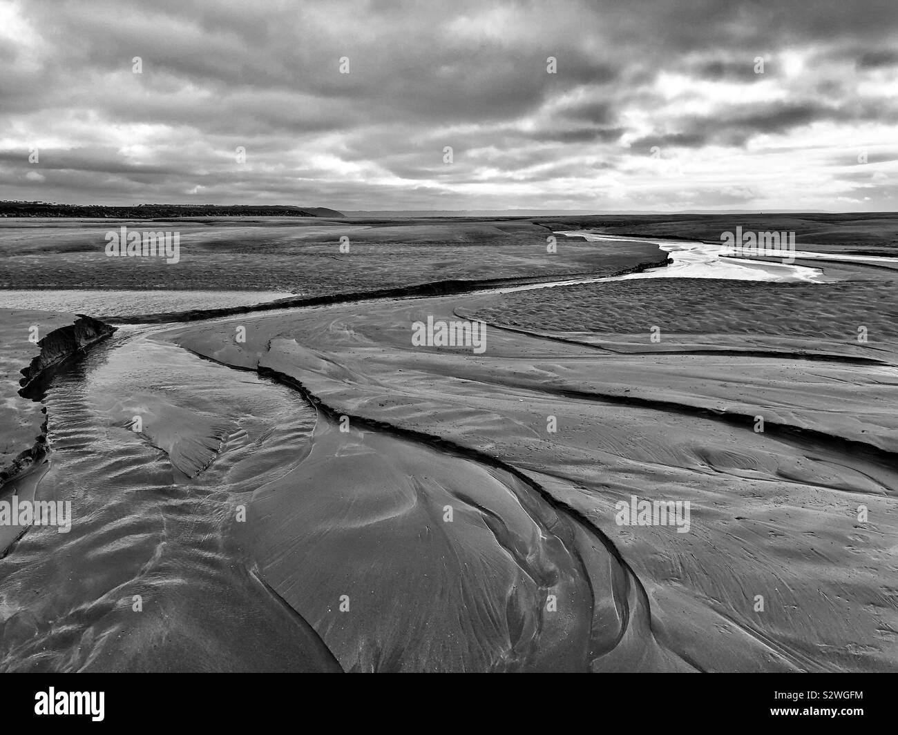 Water running through sandy river bank to the sea, River Torridge estuary, Appledore, Northam burrows. - Smartphone Captured Stock Image
