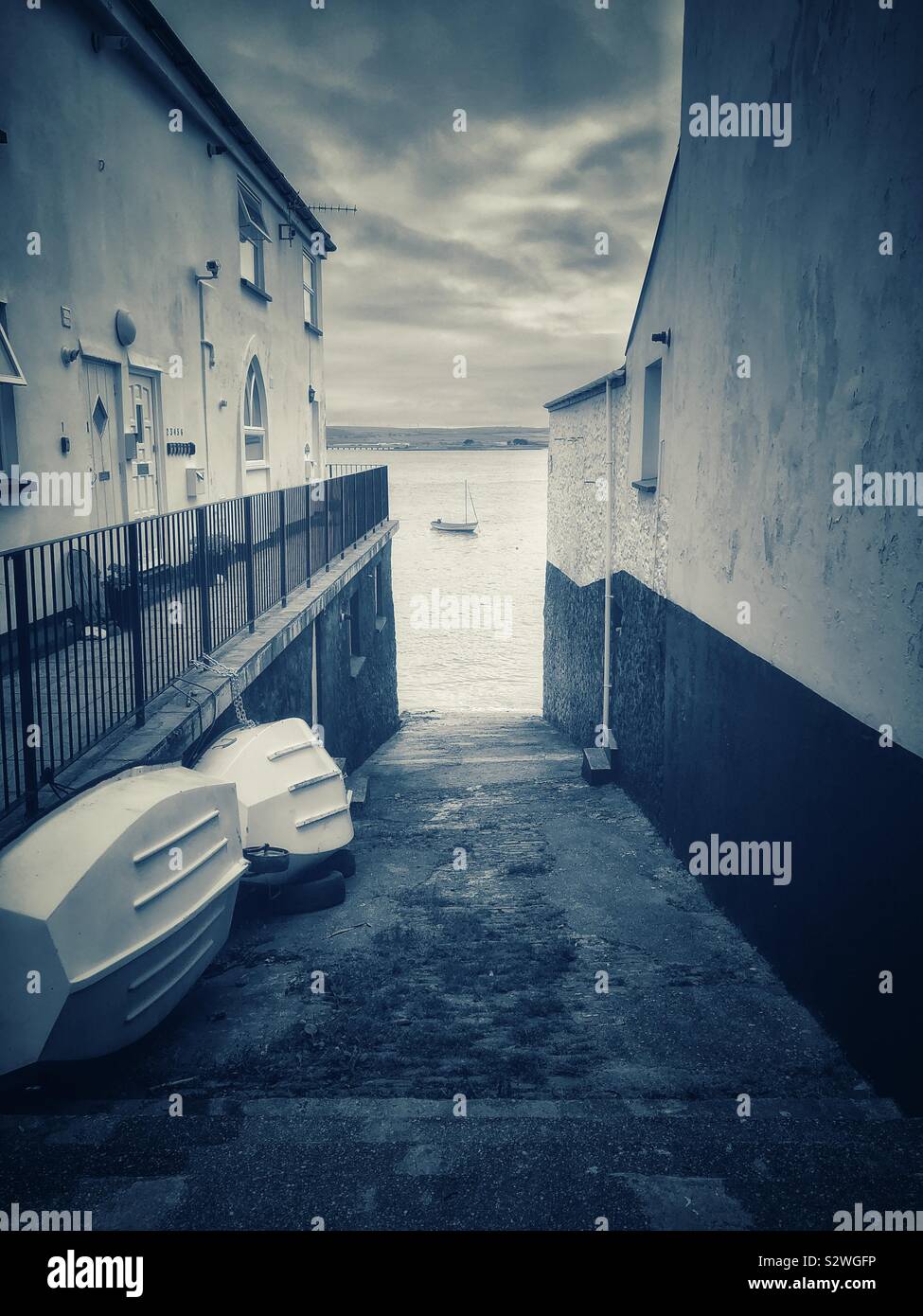 A view of the Torridge estuary through the gap between houses on Irsha street, Appledore, Devon. - Smartphone Captured Stock Image