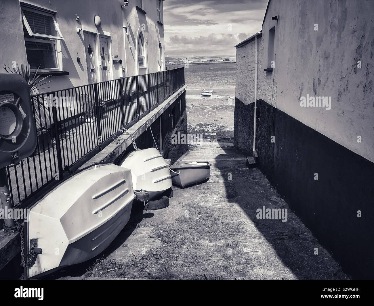 View of the river Torridge estuary through a gap between two houses on Irsha street, Appledore. - Smartphone Captured Stock Image