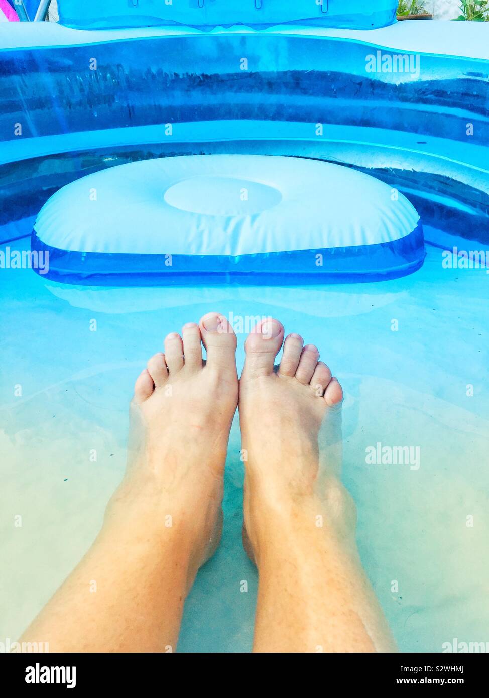 Natural woman’s feet in paddling pool toes - Smartphone Captured Stock Image