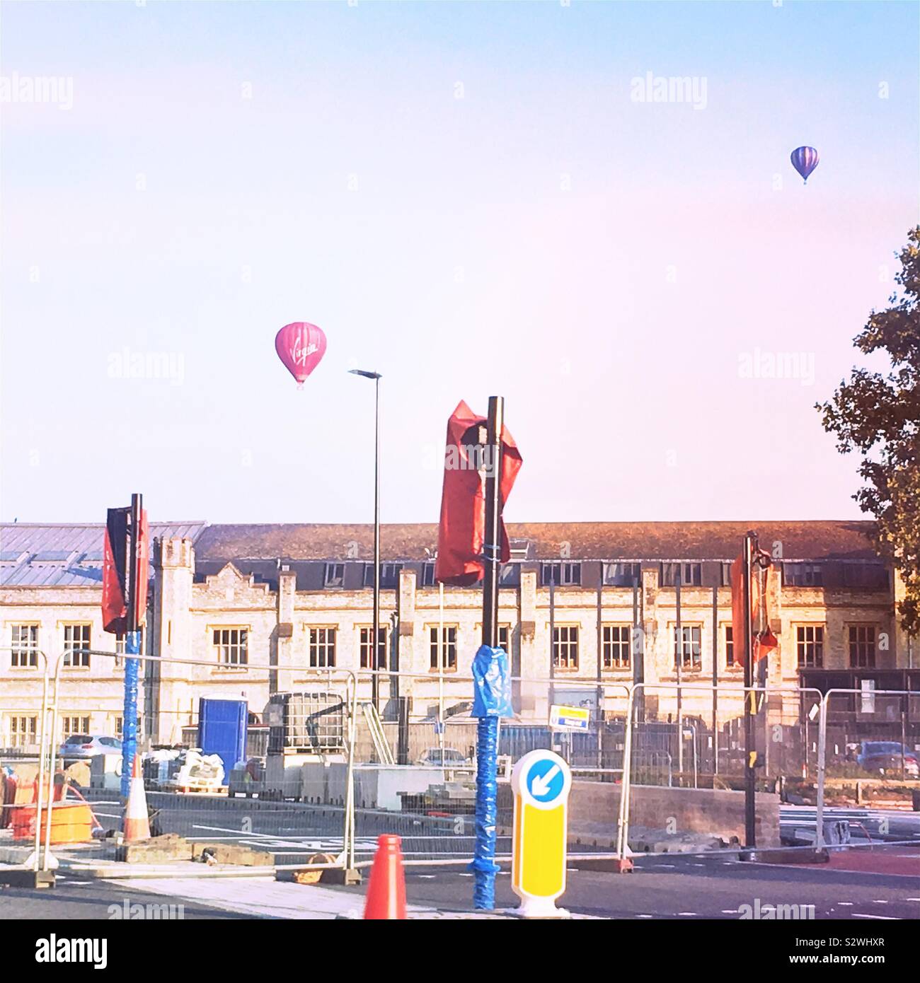 Redevelopment of the Temple Meads area of Bristol, England, with old railway buildings, covered traffic lights and hot air balloons Stock Photo