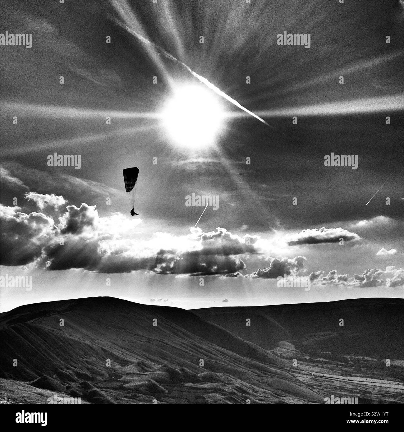 Paragliding silhouette against the sun over Derbyshire Stock Photo