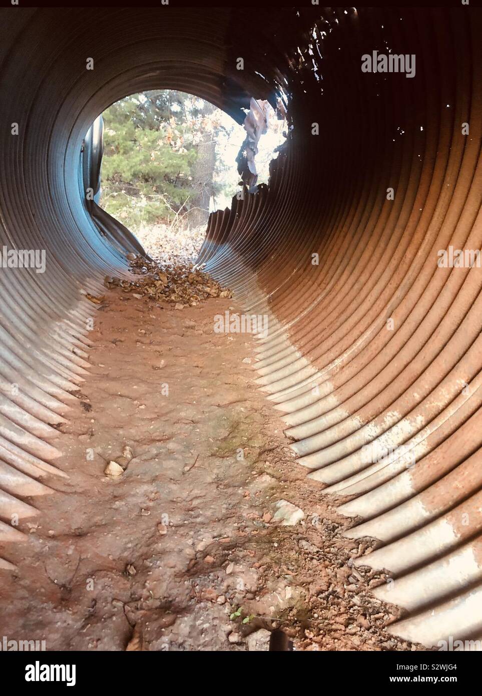 Old rustic pipe tunnel Stock Photo