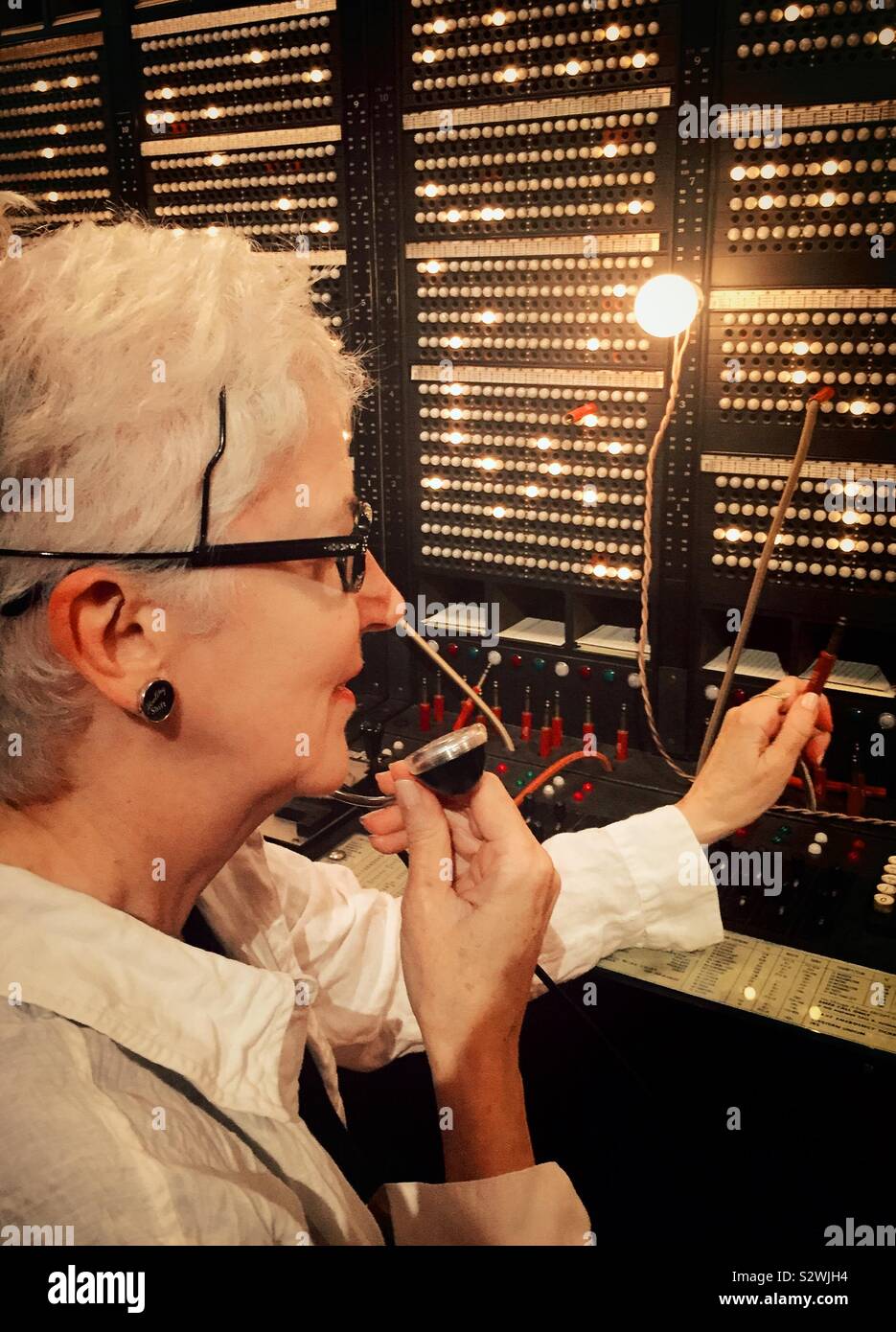 Vintage telephone operator at a historical 1950 switchboard, USA - Smartphone Captured Stock Image