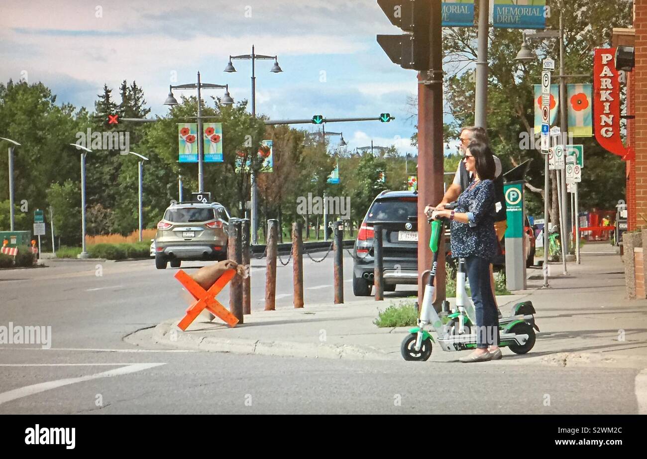 Street photography in Kensington in Calgary, Alberta, Canada, electric scooters - Smartphone Captured Stock Image