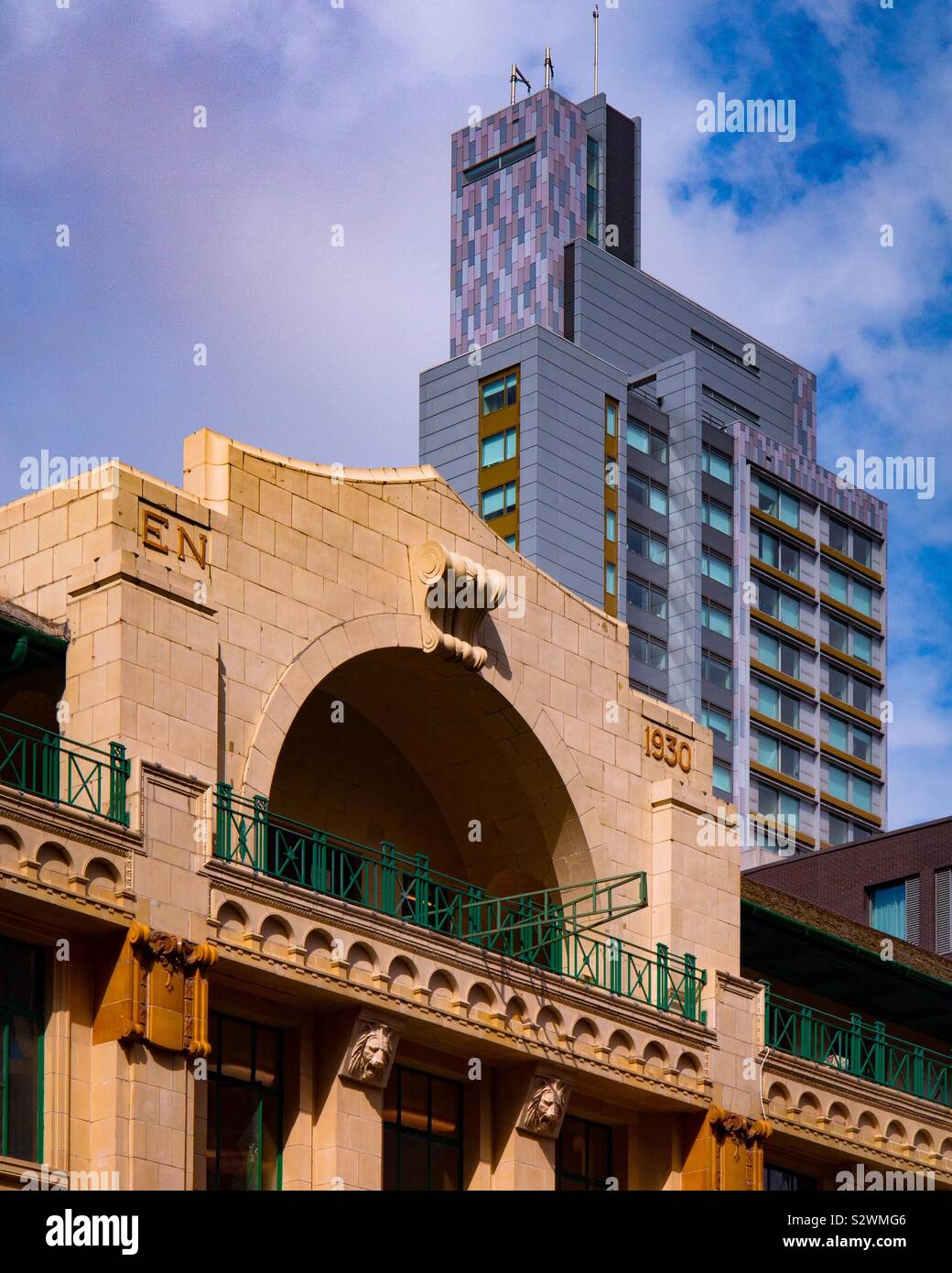 Art Deco building with modern tower block in background in Manchester city centre England UK - Smartphone Captured Stock Image