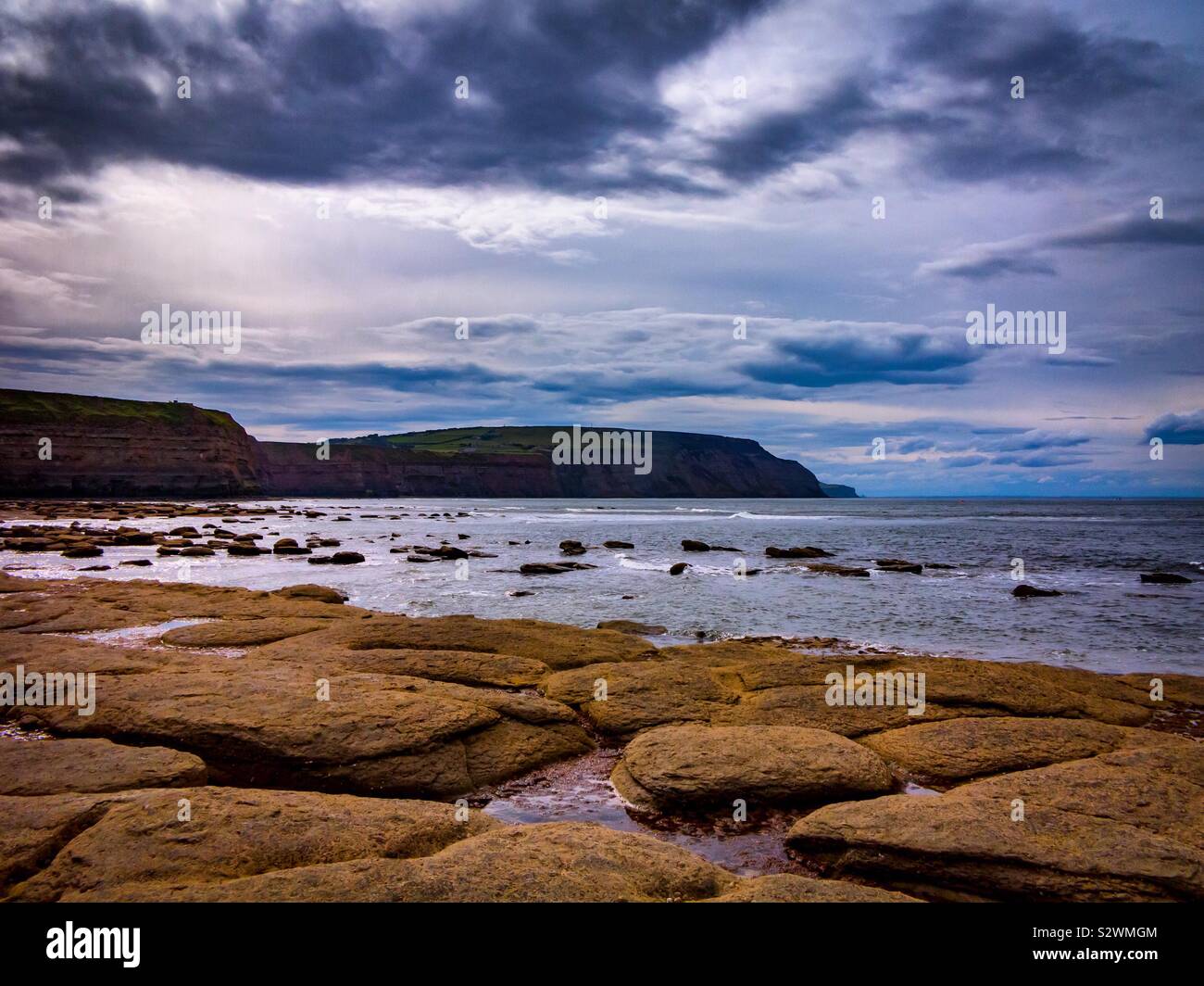 The beach and cliffs at Staithes a coastal village on the North Yorkshire coast England UK - Smartphone Captured Stock Image