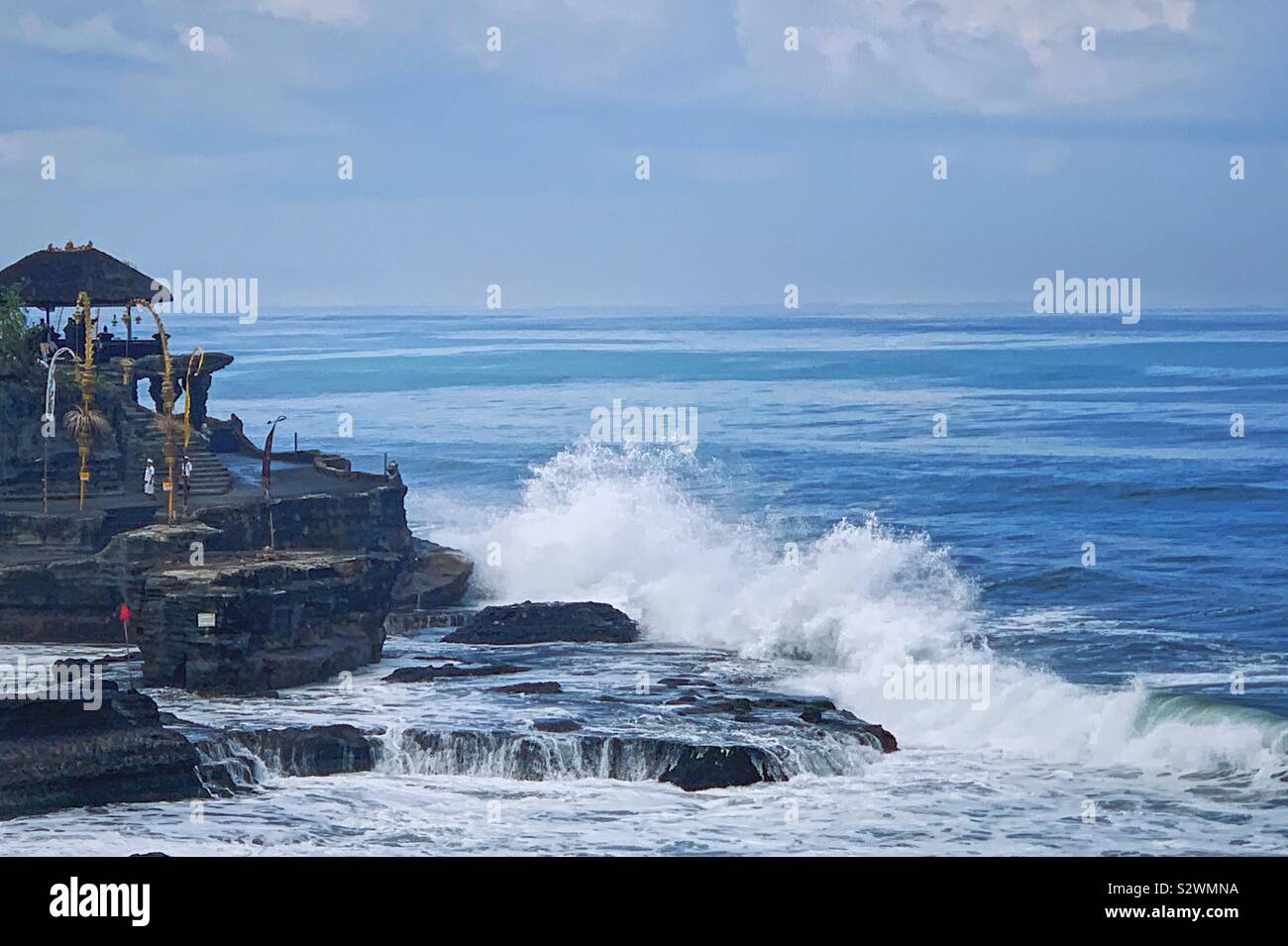 The sea temple of Tanah Lot in Bali Indonesia at low tide. August 2019 - Smartphone Captured Stock Image