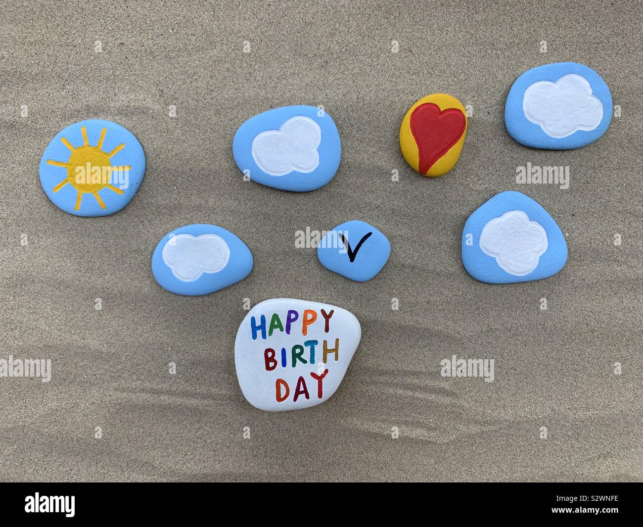 Creative Happy Birthday stones composition on the sand - Smartphone Captured Stock Image
