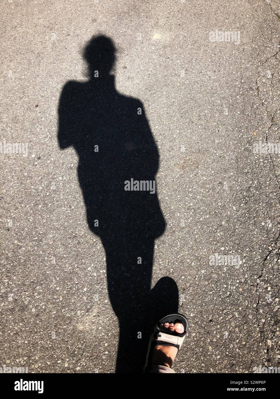 The shadow of a person walking. - Smartphone Captured Stock Image