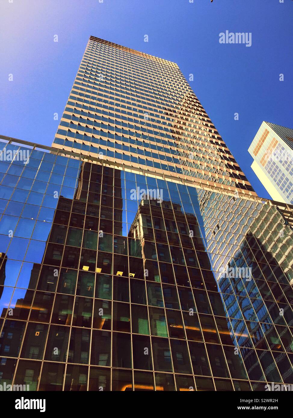 Reflections of skyscrapers on the glass façade of 300 Madison