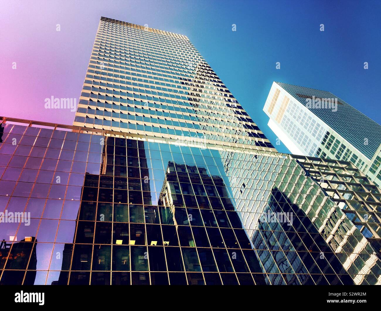 Reflections of skyscrapers on the glass façade of 300 Madison Ave ...