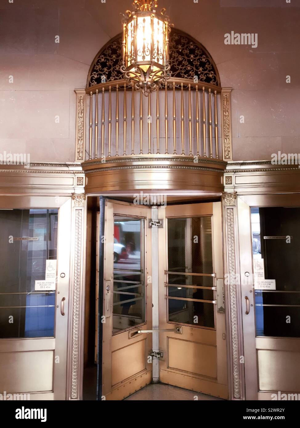 Ornate brass revolving doors at entrance to One Grand Central Pl