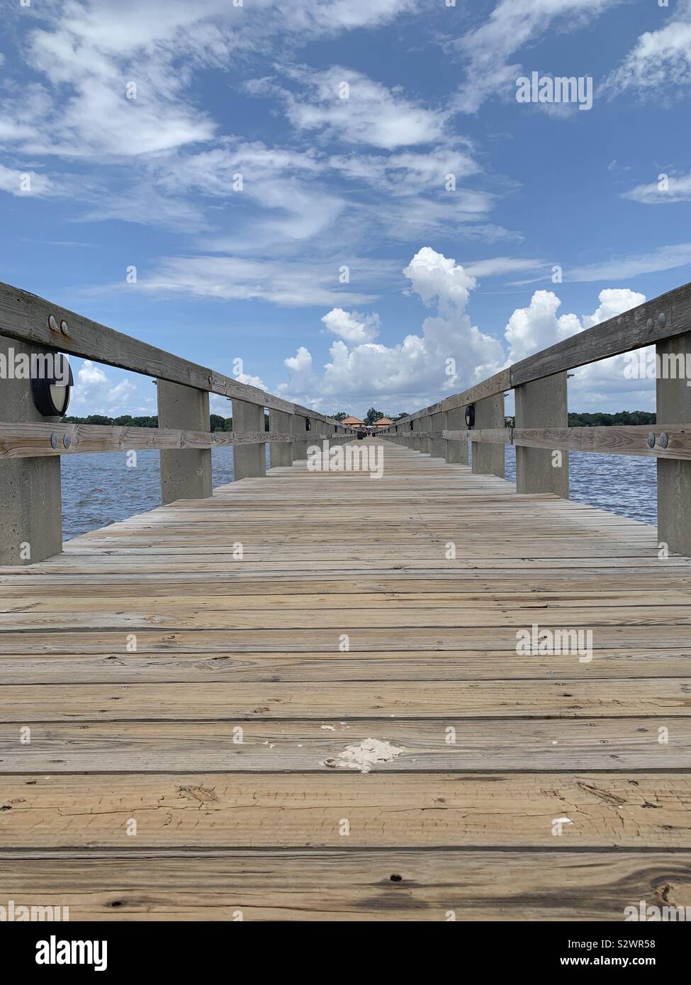 Wooden pier shot low looking towards beach area in Gulfport, Mississippi Stock Photo