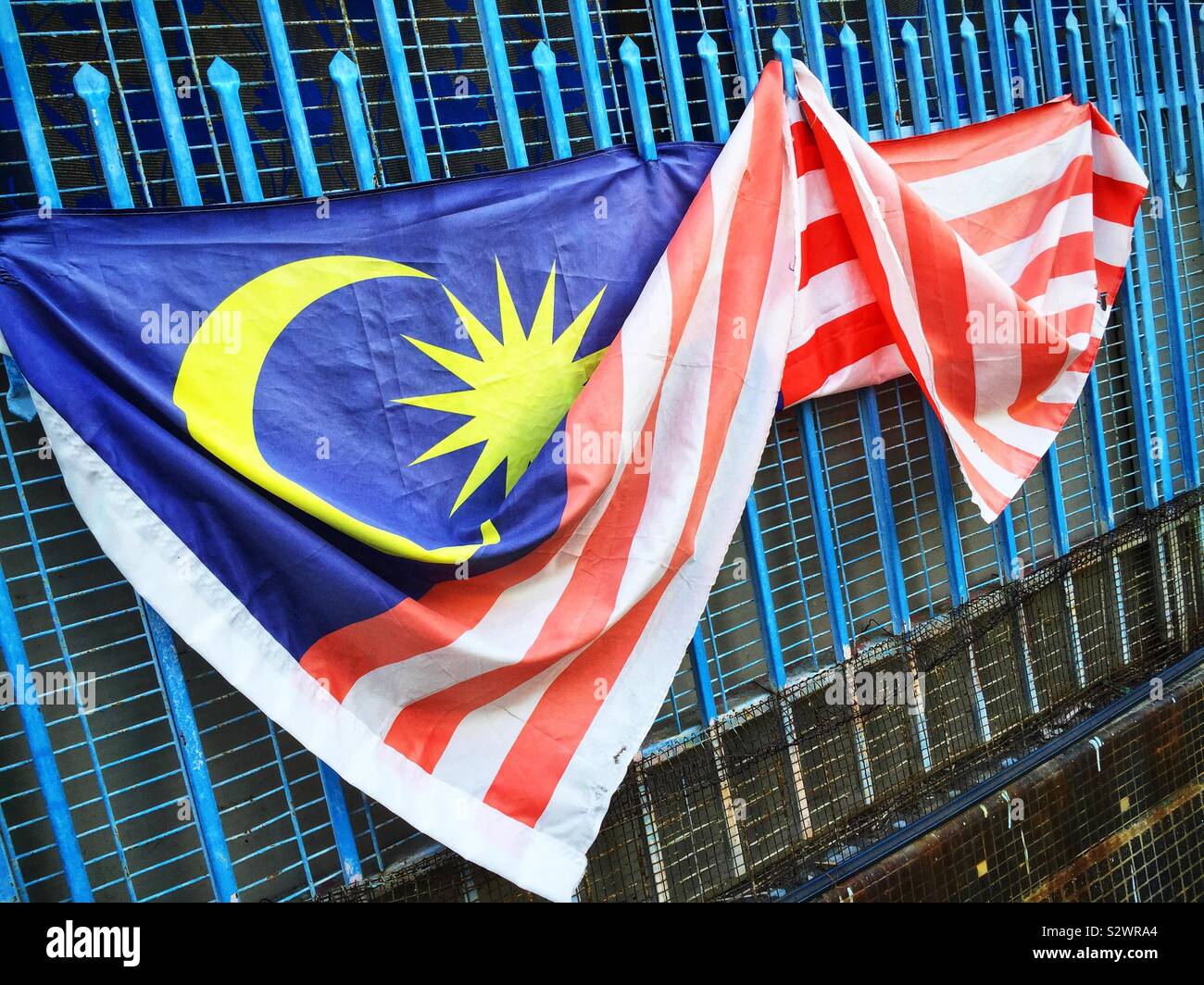 The Malaysian national flag outside a house in the Old Town of George Town, Penang, Malaysia - Smartphone Captured Stock Image